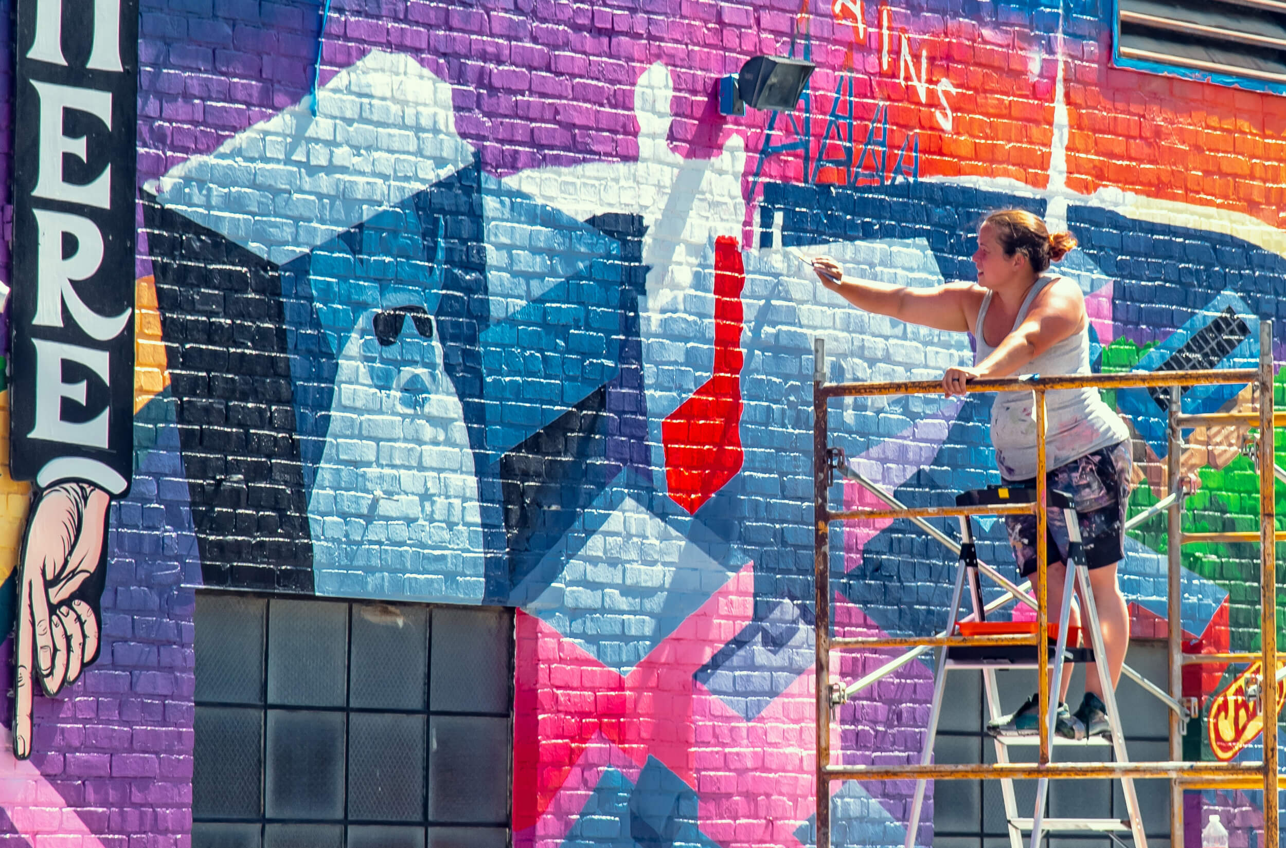 woman painting a mural .