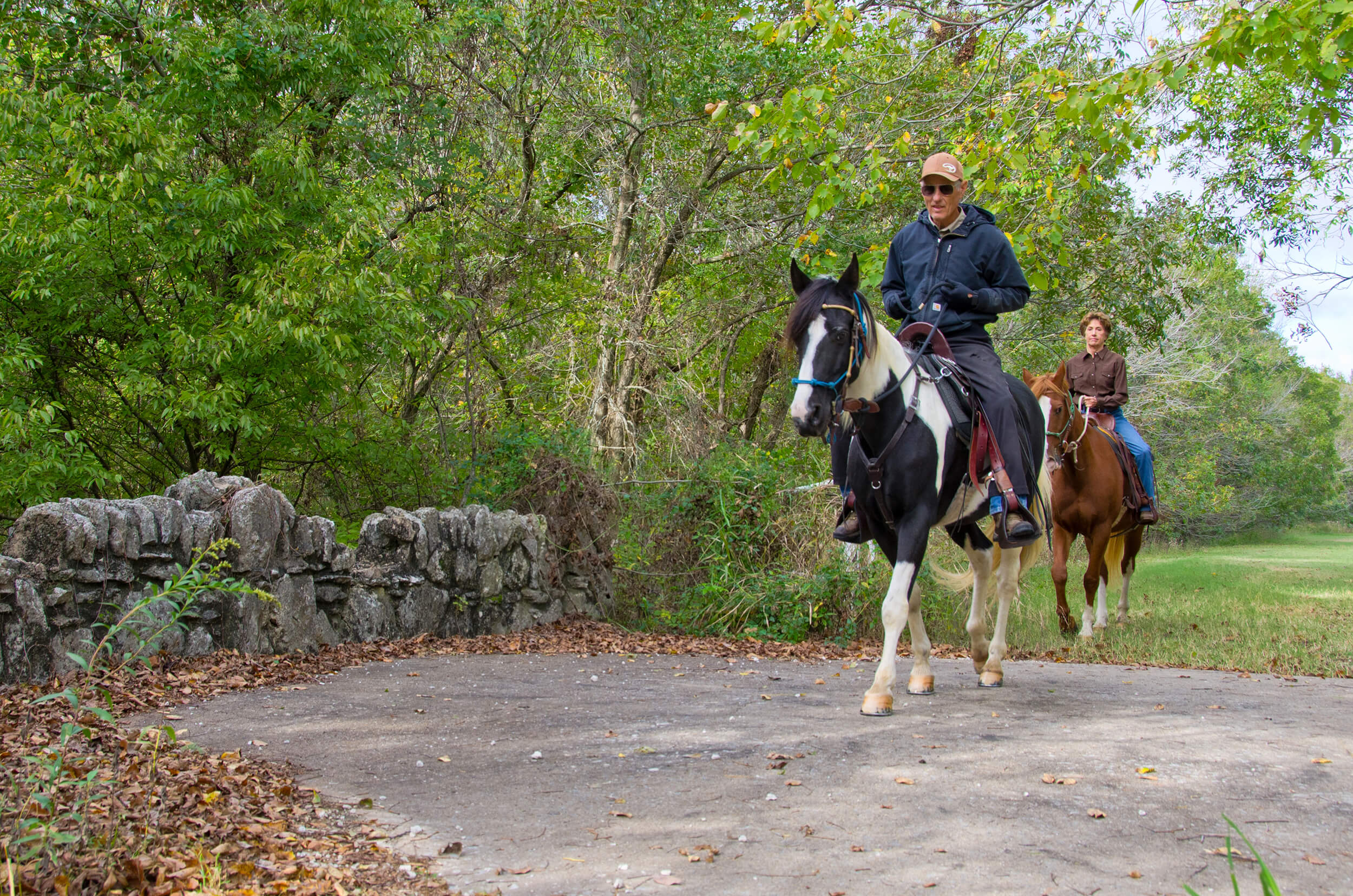 two people horseback riding in mohawk park.